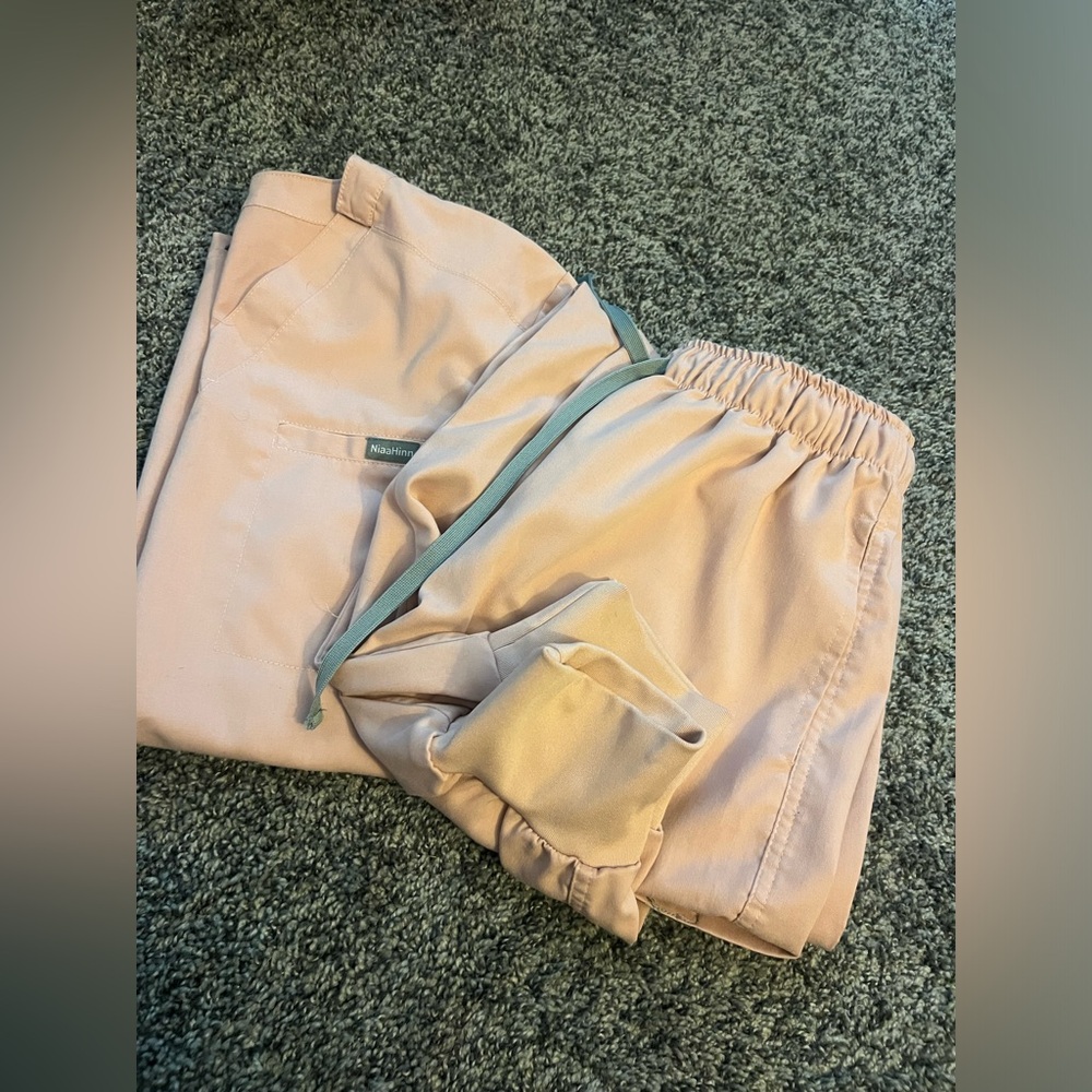 2 sets of scrubs. Both different brands. Both are size large as seen in photos.